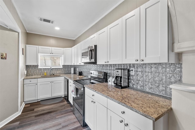 kitchen featuring sink, stainless steel appliances, light stone countertops, white cabinets, and decorative backsplash