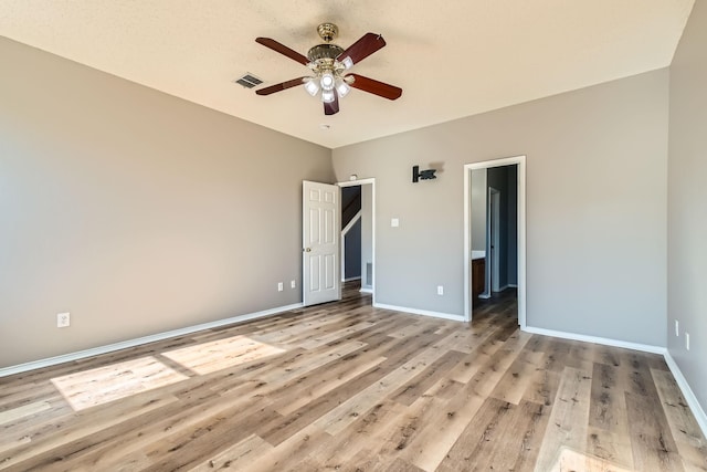 unfurnished bedroom with ceiling fan and light wood-type flooring