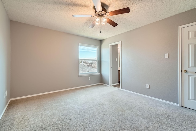 unfurnished room featuring ceiling fan, light carpet, and a textured ceiling