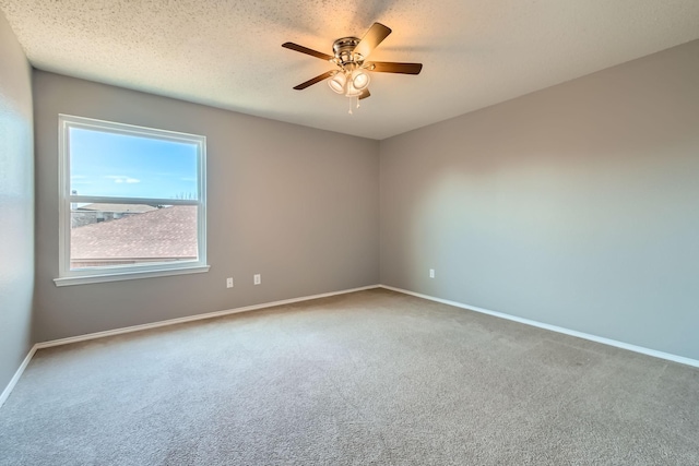 carpeted empty room with a textured ceiling and ceiling fan