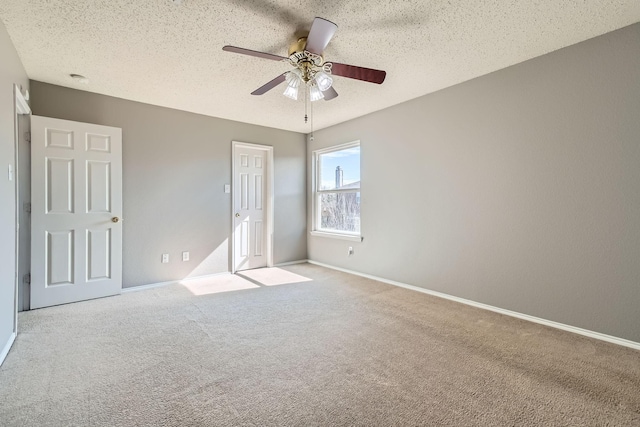 unfurnished bedroom with ceiling fan, light carpet, and a textured ceiling