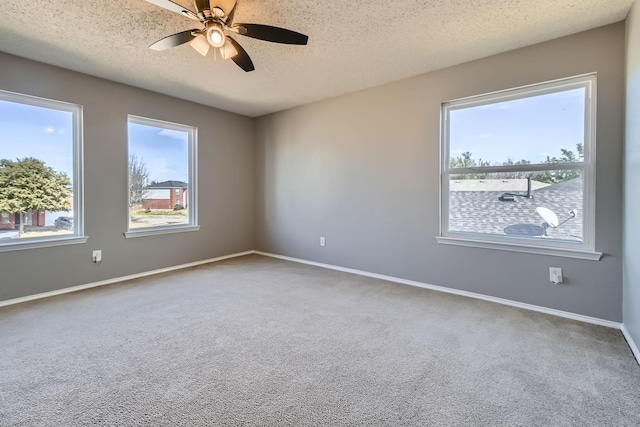 unfurnished room featuring ceiling fan, a textured ceiling, and carpet flooring