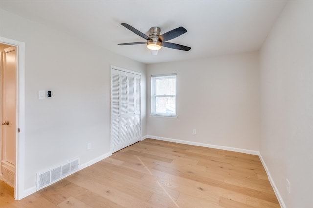 unfurnished bedroom featuring light hardwood / wood-style floors, a closet, and ceiling fan