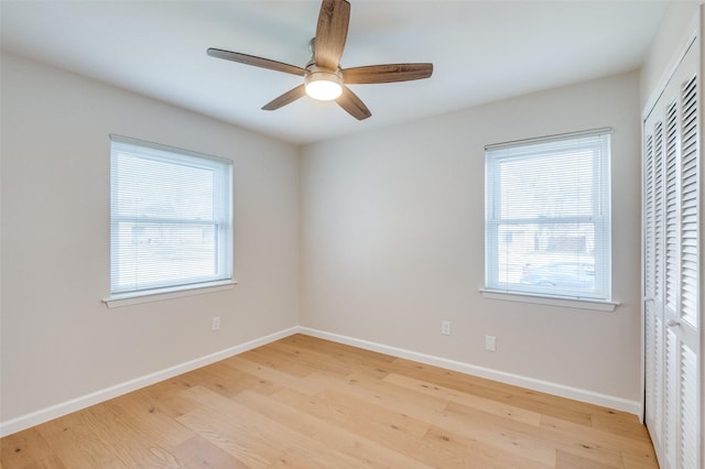 empty room featuring ceiling fan, plenty of natural light, and light hardwood / wood-style floors