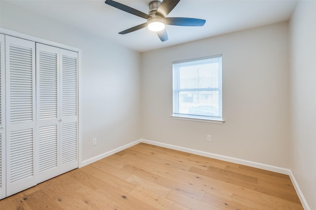 unfurnished bedroom featuring ceiling fan, a closet, and light hardwood / wood-style flooring