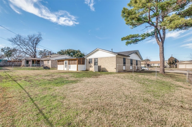 rear view of property with a lawn