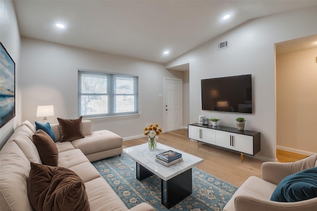 living room with lofted ceiling and light wood-type flooring