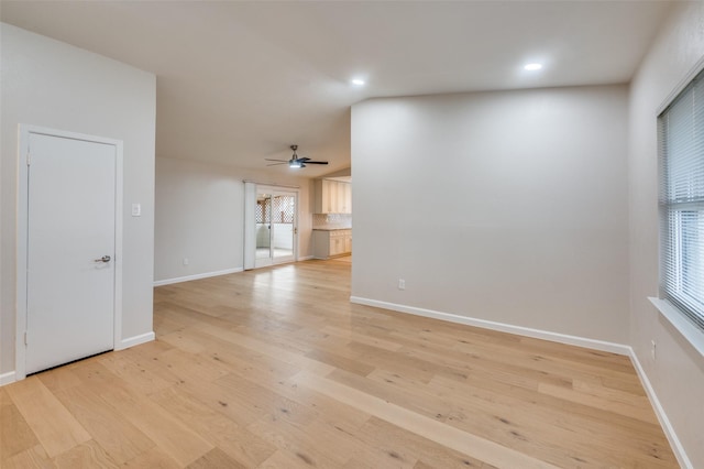 unfurnished living room featuring ceiling fan and light wood-type flooring