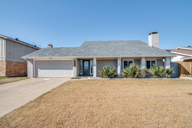 single story home featuring a garage and a front lawn