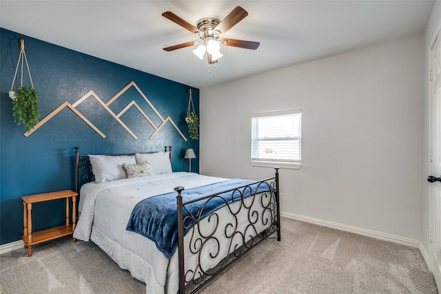 bedroom featuring ceiling fan and carpet