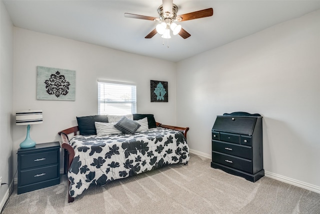 bedroom featuring light colored carpet and ceiling fan