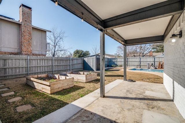 view of patio with a storage shed and a fenced in pool