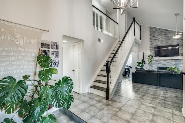 stairway featuring a towering ceiling and an inviting chandelier