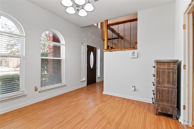 entryway featuring a chandelier and light wood-type flooring