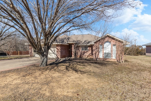 single story home with a garage and a front lawn