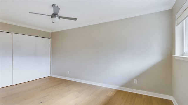 unfurnished bedroom with crown molding, ceiling fan, light hardwood / wood-style floors, and a closet