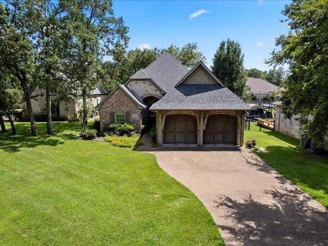 view of front facade with a garage and a front lawn