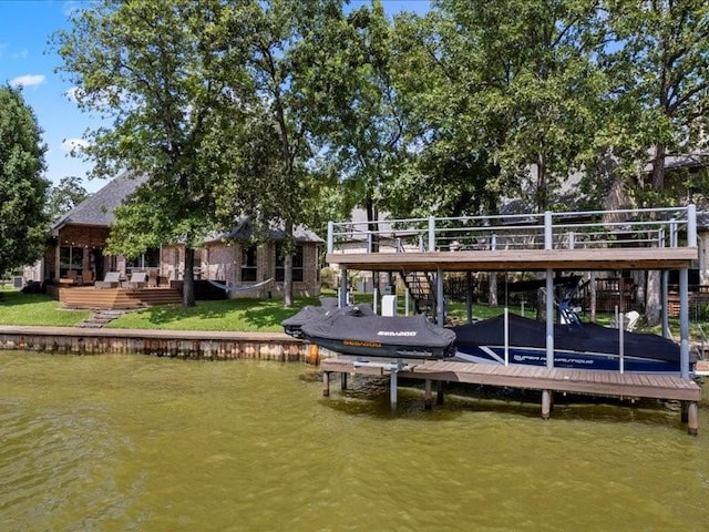 view of dock featuring a deck with water view and boat lift