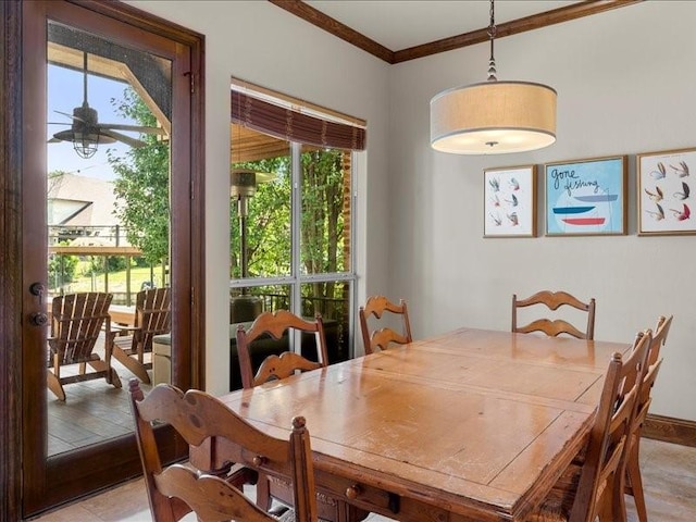 dining space with baseboards, a ceiling fan, and crown molding