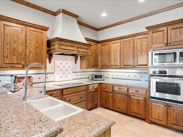 kitchen with sink, black electric cooktop, ornamental molding, dishwasher, and custom range hood