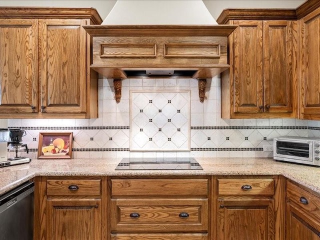 kitchen featuring black electric cooktop, a toaster, stainless steel dishwasher, brown cabinets, and decorative backsplash