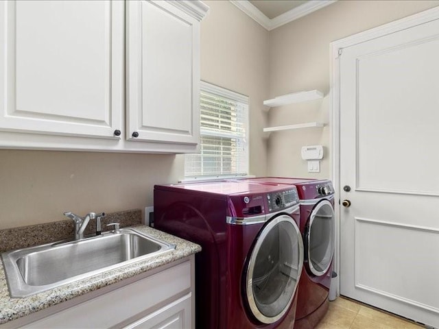 laundry area featuring separate washer and dryer, sink, ornamental molding, and cabinets