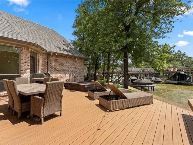 wooden deck with outdoor dining area and hot tub deck surround