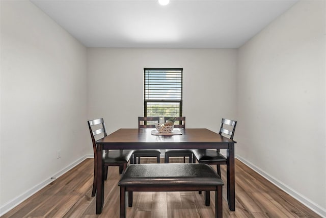 dining room with dark hardwood / wood-style flooring