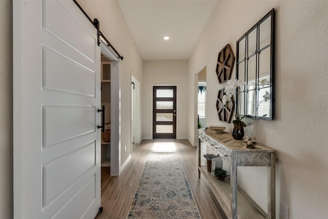 doorway with hardwood / wood-style flooring and a barn door