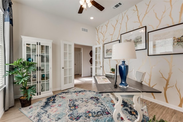 office space featuring light hardwood / wood-style floors, french doors, and ceiling fan