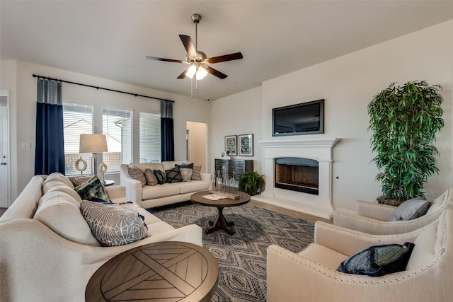 living room with ceiling fan and dark hardwood / wood-style flooring