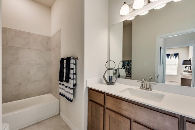 full bathroom featuring tile patterned floors, toilet, tiled shower / bath combo, and vanity