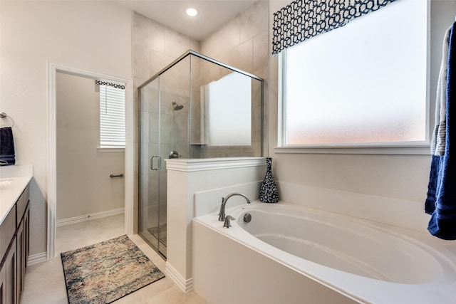 bathroom featuring tile patterned flooring, shower with separate bathtub, and vanity