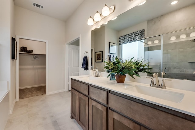 bathroom with vanity and a shower with door