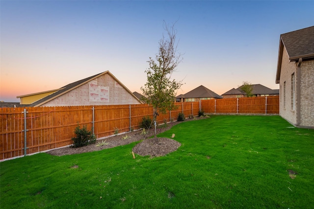 view of yard at dusk