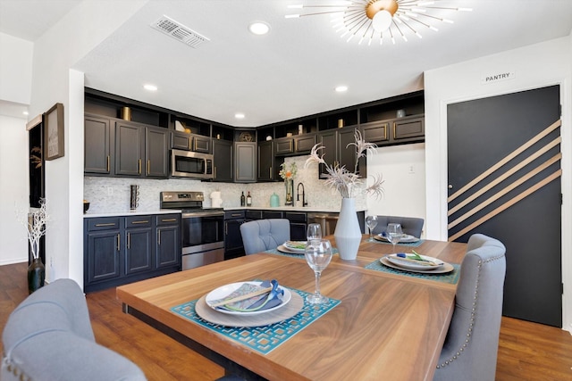 dining area with sink and dark hardwood / wood-style floors