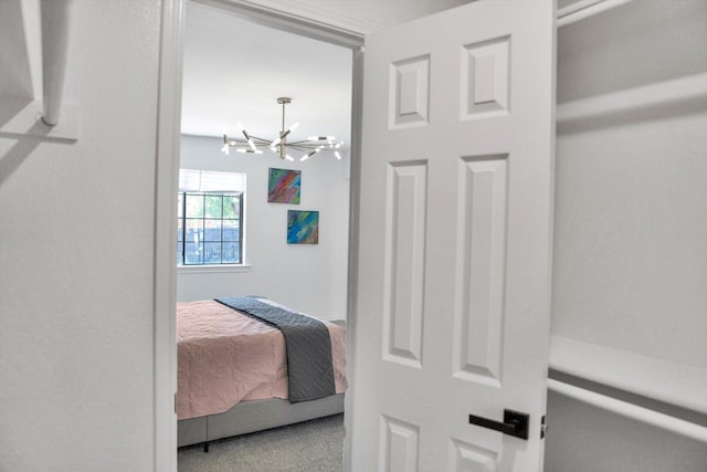 bedroom featuring carpet flooring and an inviting chandelier