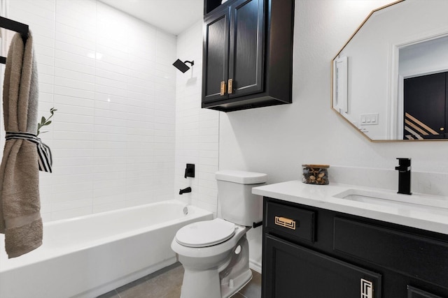 full bathroom featuring vanity, tile patterned floors, toilet, and tiled shower / bath