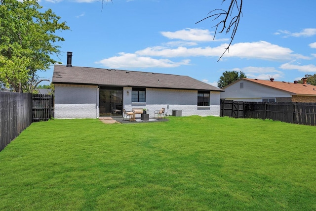 rear view of property featuring a patio and a yard