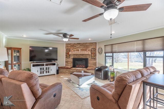 living room featuring crown molding, ceiling fan, a brick fireplace, and light tile patterned floors