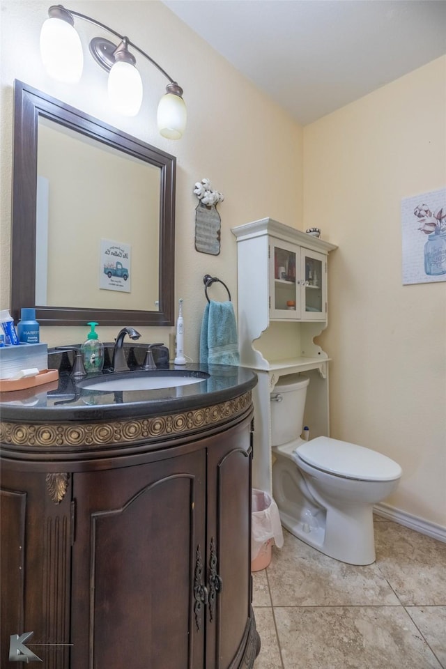 bathroom featuring vanity, tile patterned floors, and toilet