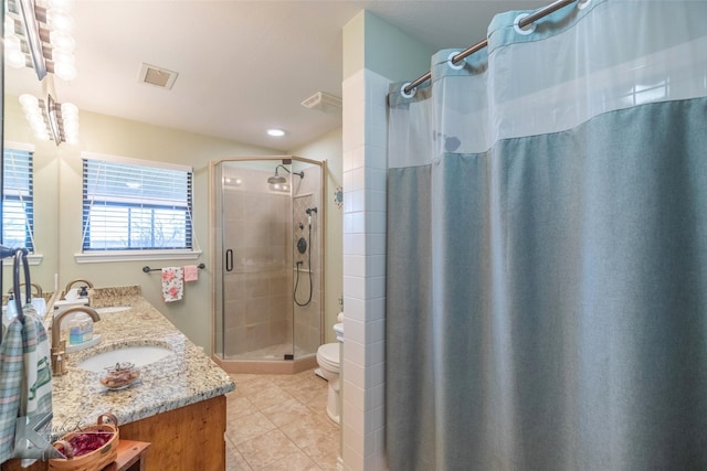 bathroom with tile patterned flooring, vanity, curtained shower, and toilet