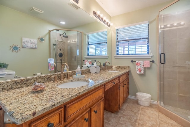 bathroom with vanity, an enclosed shower, and tile patterned flooring