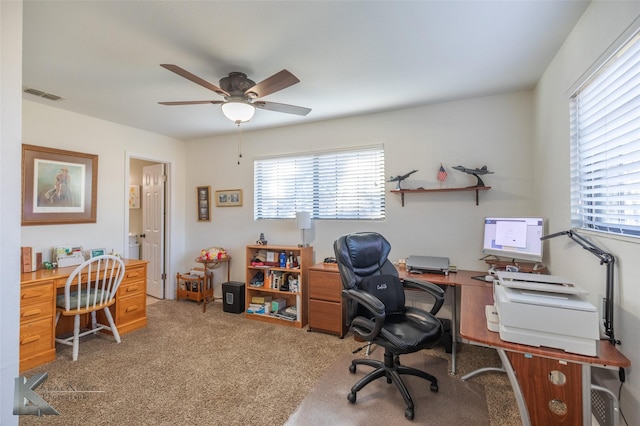 home office with ceiling fan and carpet flooring