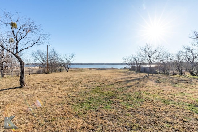 view of yard with a water view and a rural view