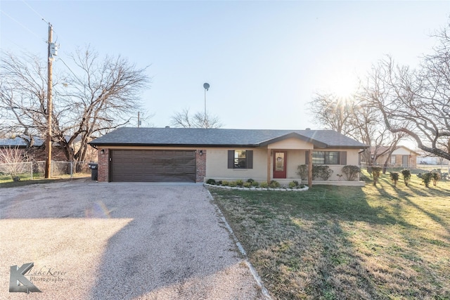 single story home featuring a garage and a front yard