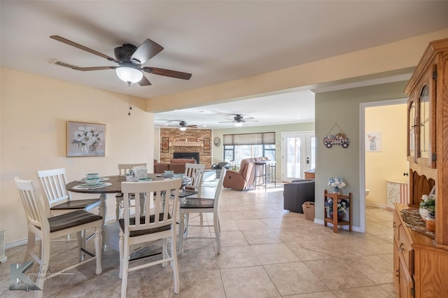 tiled dining area featuring a fireplace