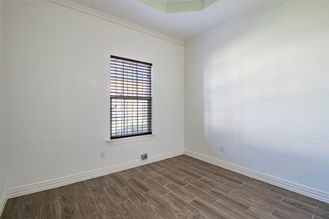 spare room with dark wood-type flooring and ornamental molding