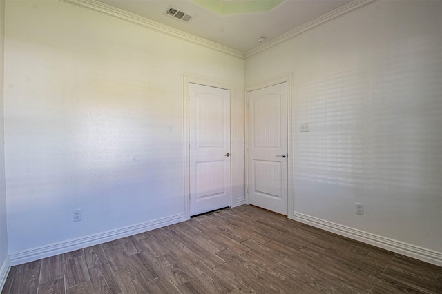 spare room with ornamental molding and wood-type flooring