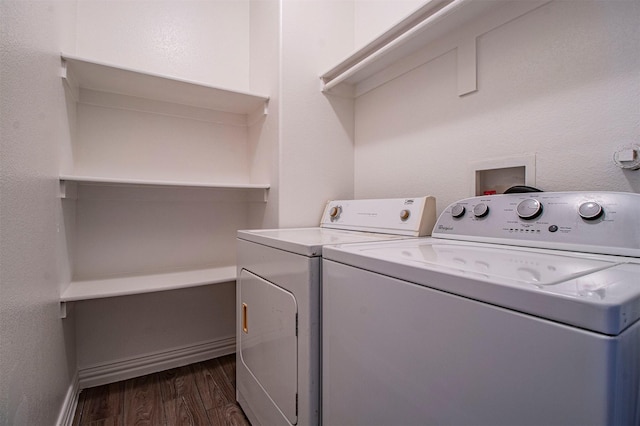 laundry room featuring dark hardwood / wood-style floors and washer and clothes dryer